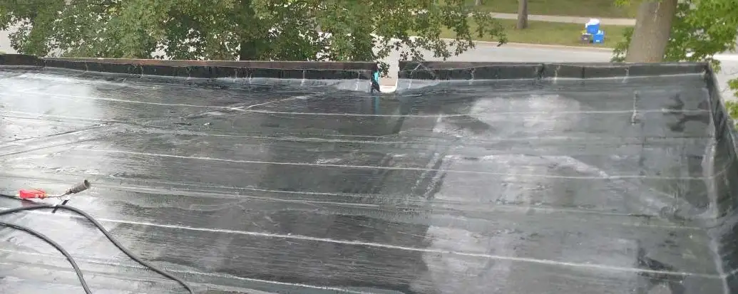 A flat roof tapered with insulation so water flows toward the drains