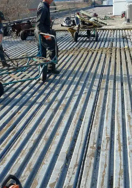 Existing flat roof stripped off with the steel deck swept clean